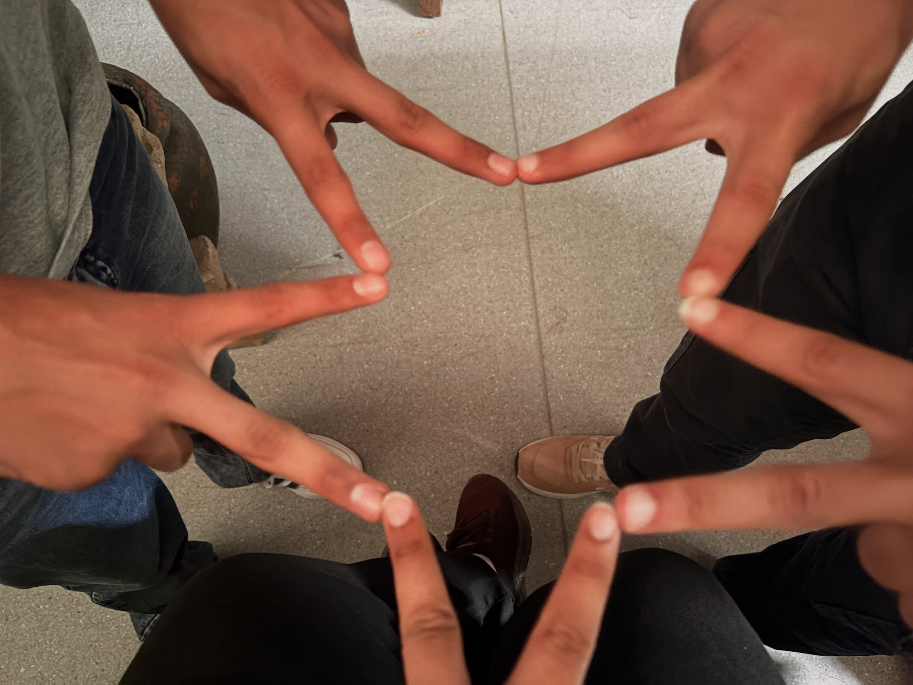 Participants forming a shared star shape with their hands during Metamorphosis