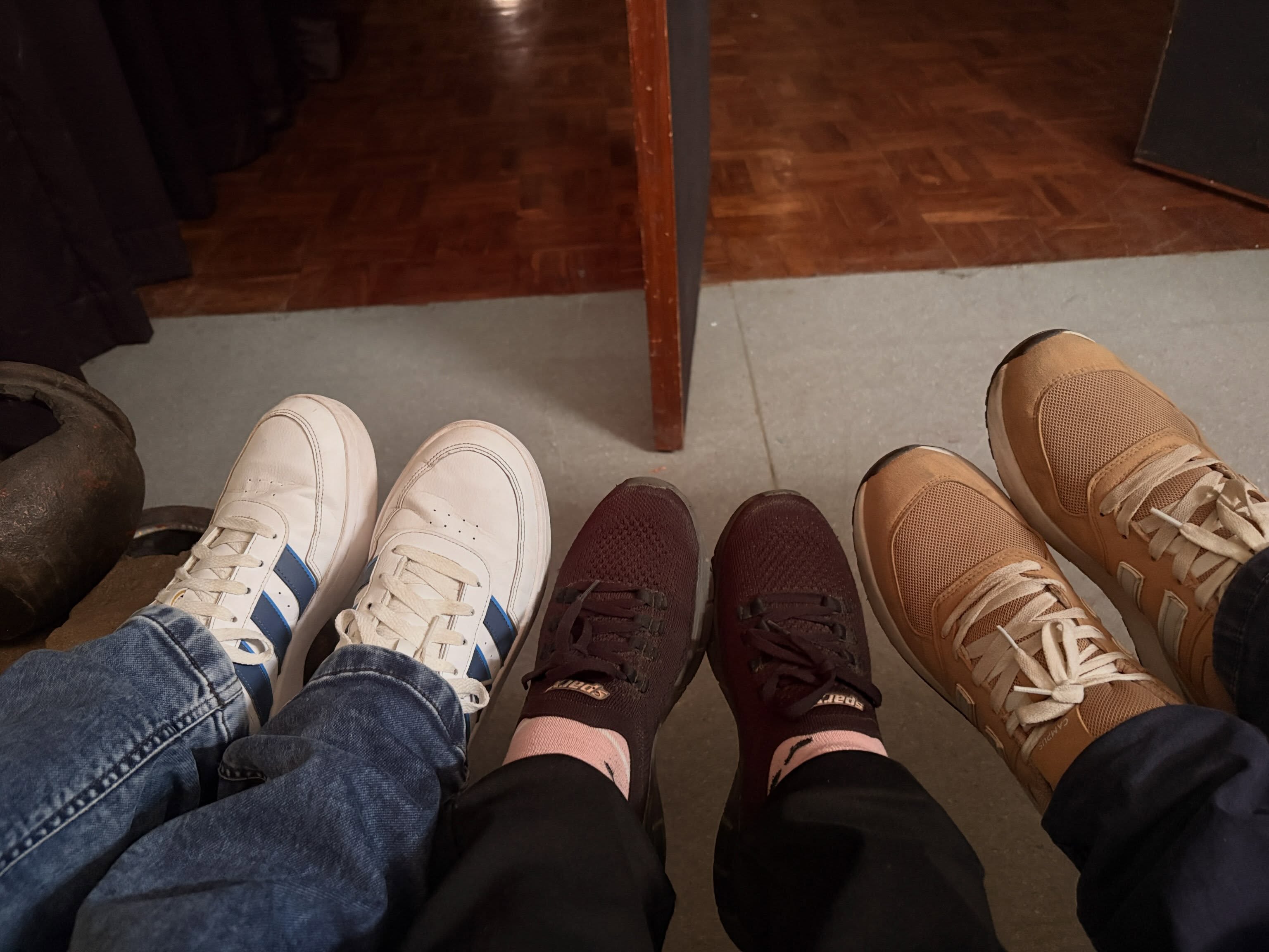 Participants’ shoes gathered in a circle during Metamorphosis